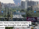 Portraits of Iranian military generals and nuclear scientists killed in Israel’s June 13, 2025, attack are displayed on a sign as a plume of heavy smoke and fire rise from an oil refinery in southern Tehran. Atta Kenare/AFP via Getty Images